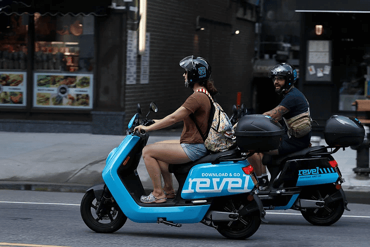 A woman and a man riding bikes