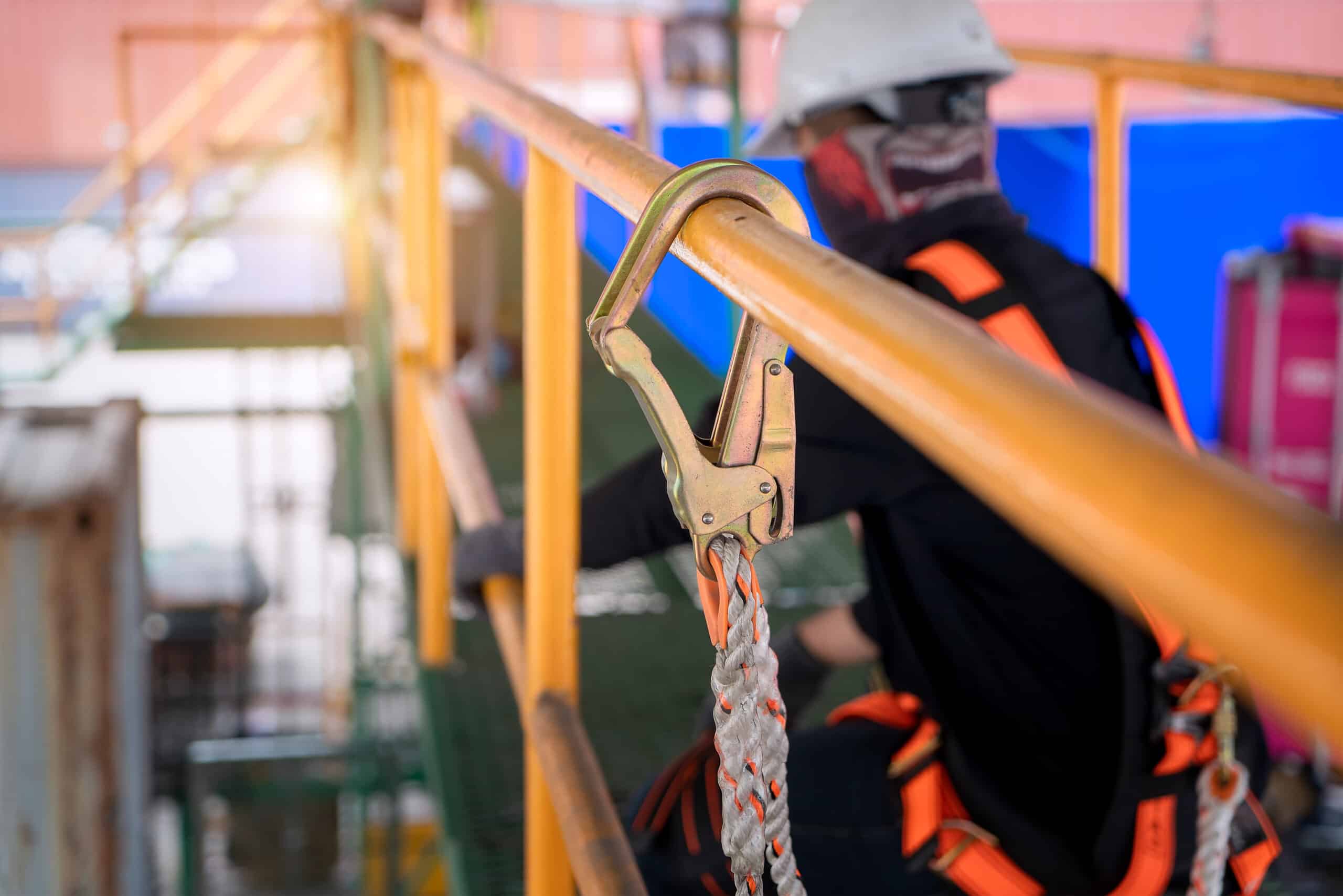 Construction worker wearing safety harness and safety line worki