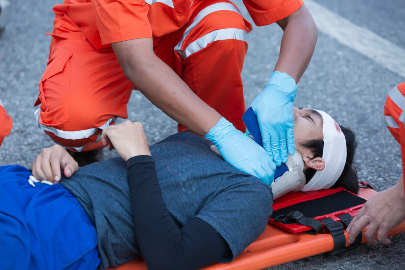Injured accident victim being assisted after suffering a catastrophic injury